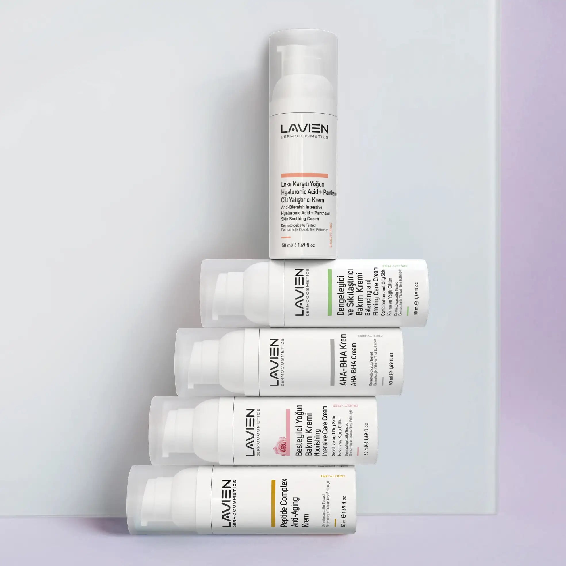 White cylindrical lavien skincare cream bottles with pump dispensers and minimalist labels.